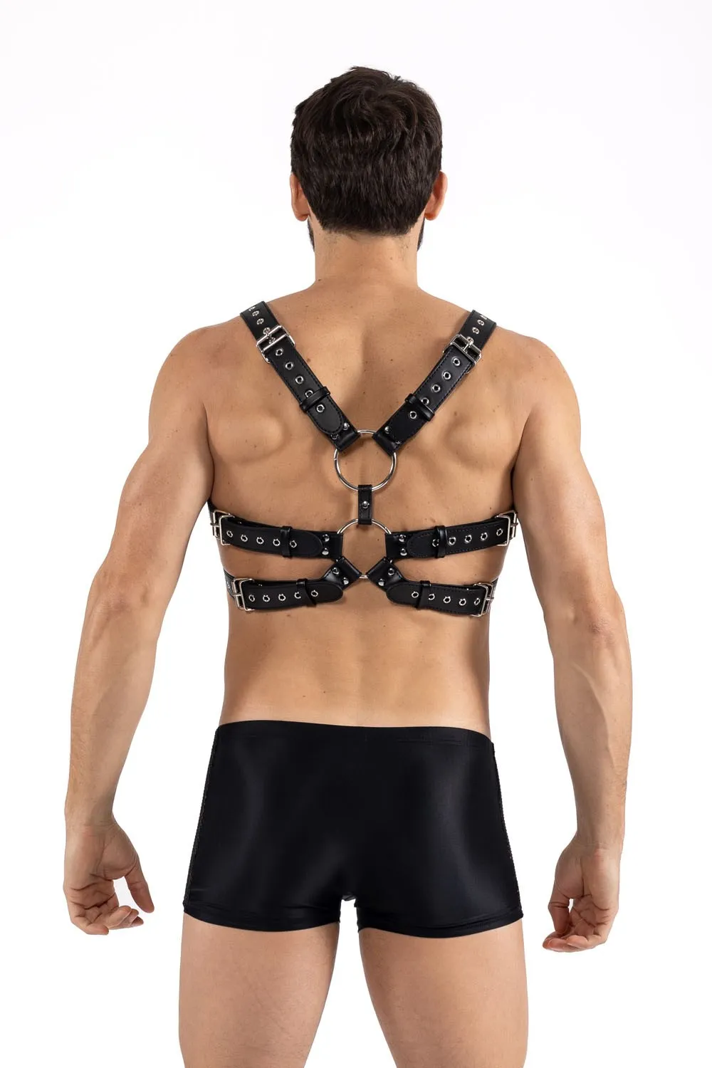 Harnais ajustable en simili cuir noir, vue arrière, avec anneaux métalliques et sangles stylées, pour un look audacieux.